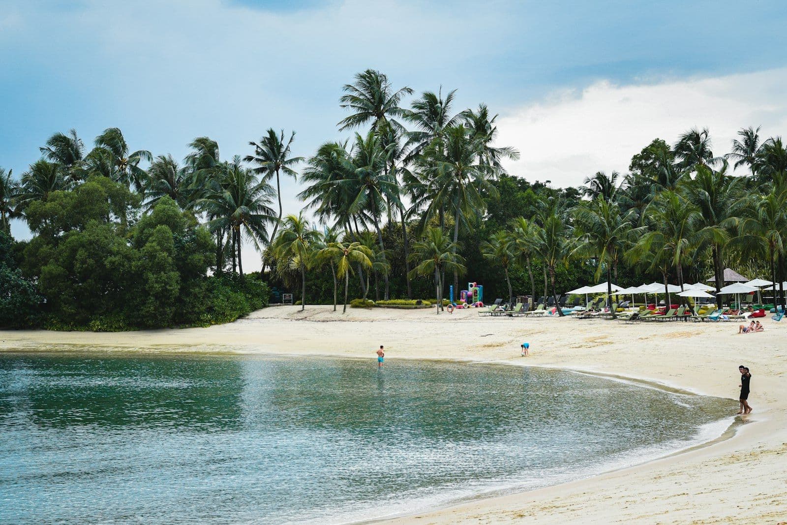 Palm trees and sun loungers on Siloso Beach, Sentosa